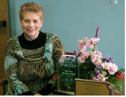 Martha, her award, and some flowers