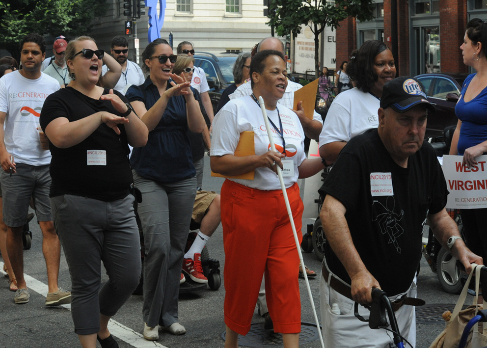 People with disabilities march through the streets