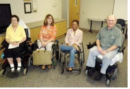 four wheelchair users in a room
